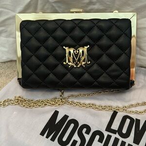 Perfect condition Black Love Moschino quilted black handbag with gold accents.